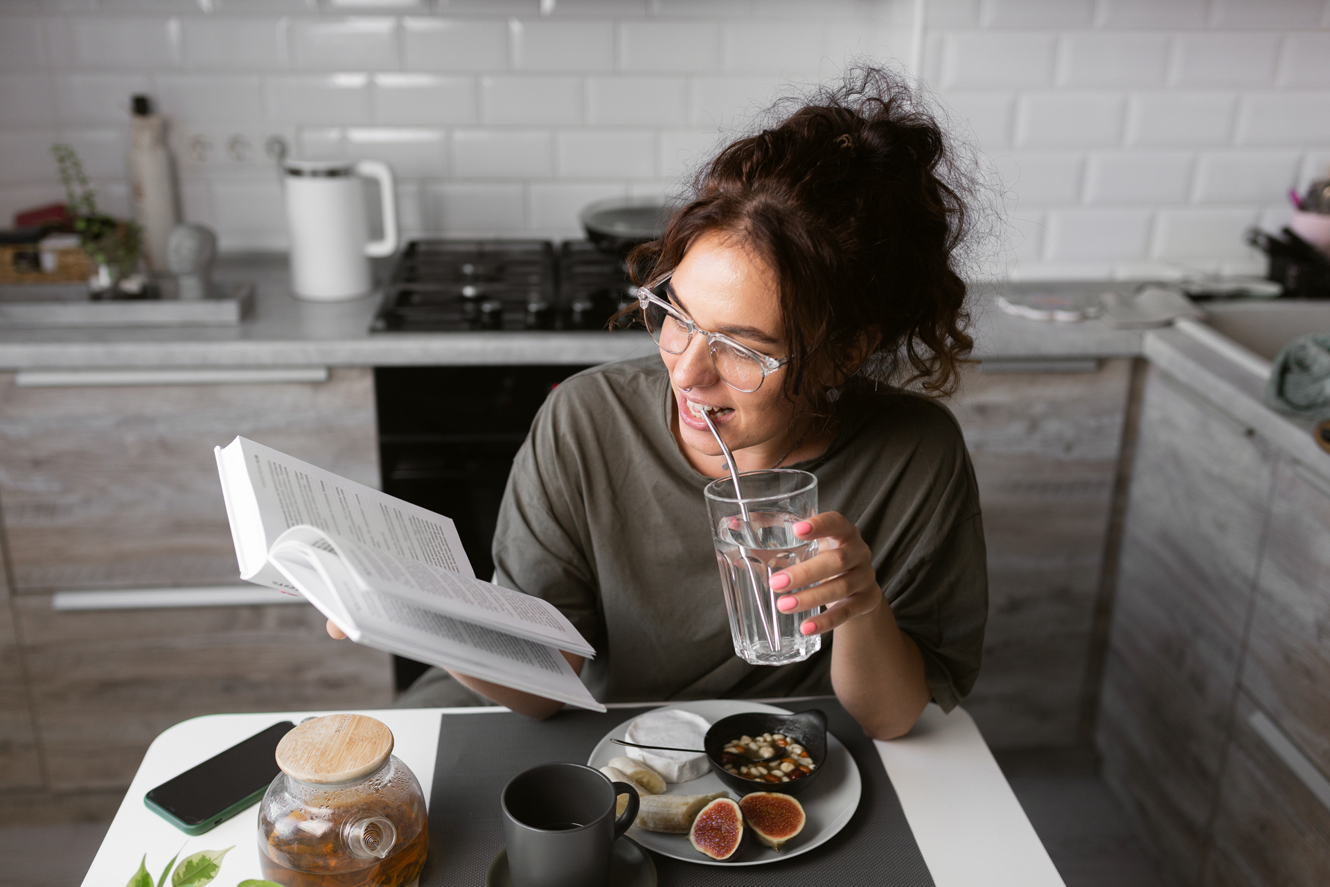 Woman drinking water while reading